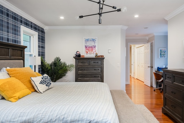 bedroom with crown molding and light hardwood / wood-style floors