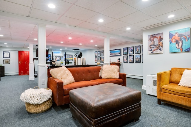 living room featuring a baseboard heating unit, carpet floors, and ornate columns