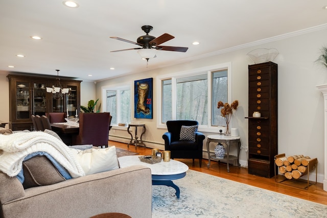 living room featuring crown molding, wood-type flooring, a baseboard radiator, and ceiling fan with notable chandelier