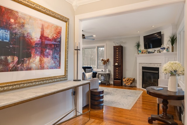 interior space featuring hardwood / wood-style floors, ornamental molding, and ceiling fan