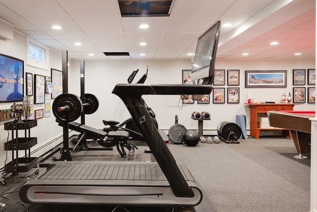 workout area featuring a paneled ceiling and carpet flooring