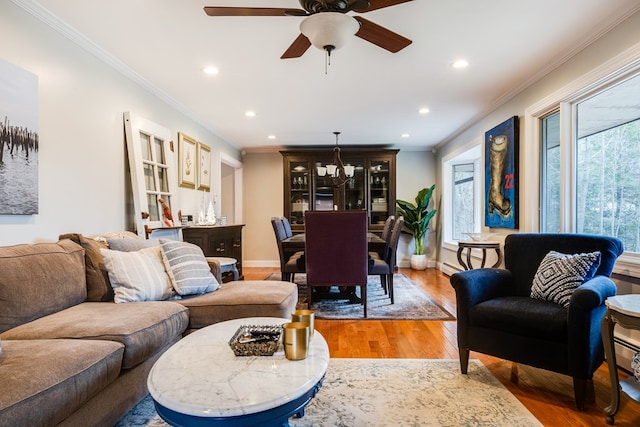 living room with ornamental molding, wood-type flooring, and plenty of natural light