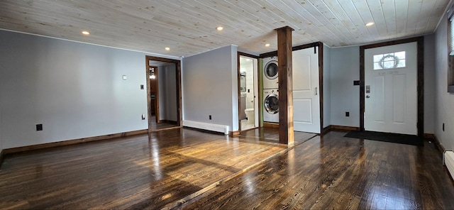 entrance foyer with dark wood-type flooring, stacked washer and clothes dryer, baseboard heating, and wooden ceiling