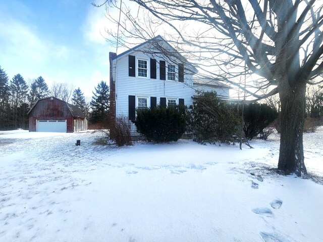 view of snow covered exterior with an outdoor structure