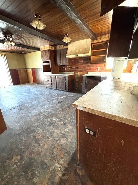 kitchen with ceiling fan, dark brown cabinets, wooden ceiling, and beamed ceiling