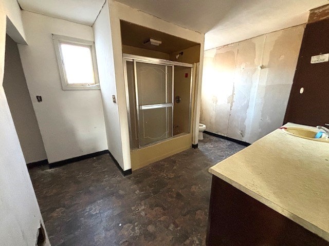 bathroom with vanity, an enclosed shower, and toilet