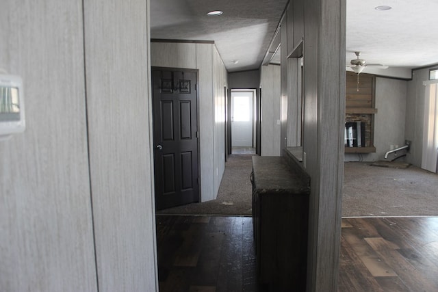 hallway featuring a textured ceiling and dark hardwood / wood-style flooring