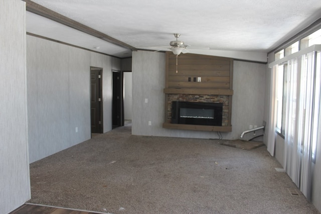 unfurnished living room with a textured ceiling, carpet floors, and ceiling fan