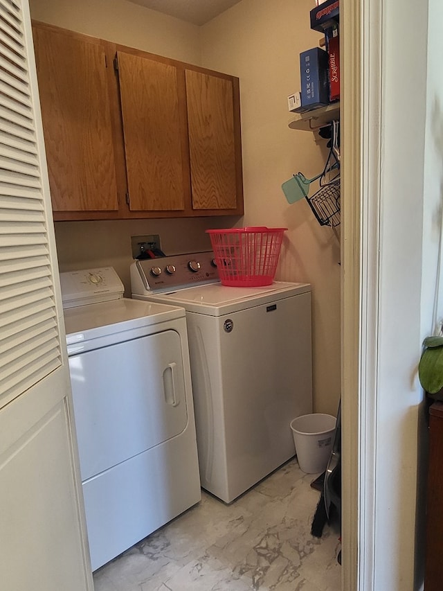 laundry area featuring cabinets and washing machine and dryer