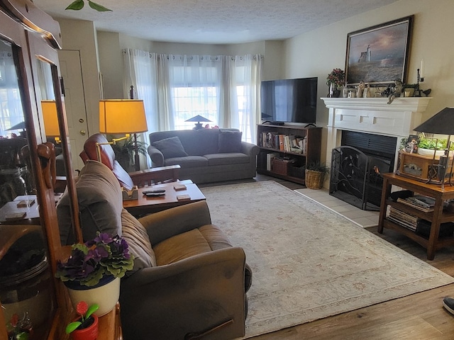 living room with light wood-type flooring and a textured ceiling