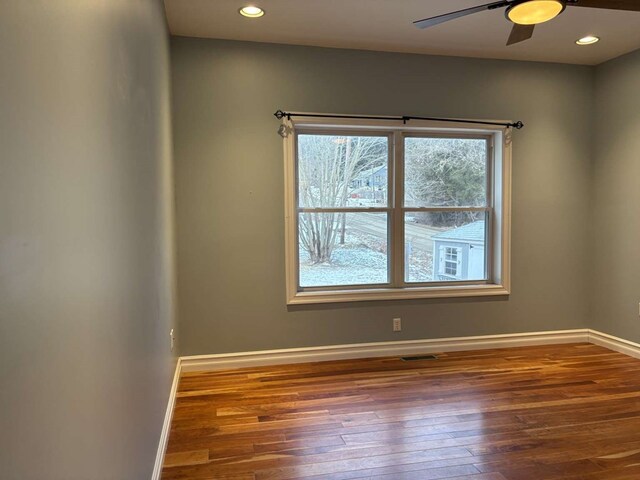 unfurnished room featuring dark hardwood / wood-style flooring and ceiling fan