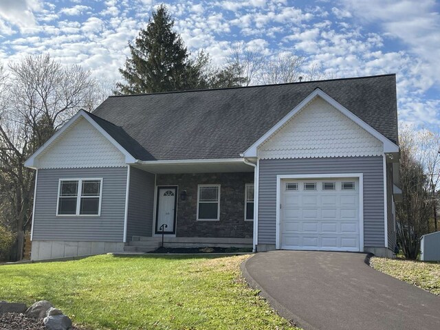 view of front of home with a garage and a front yard