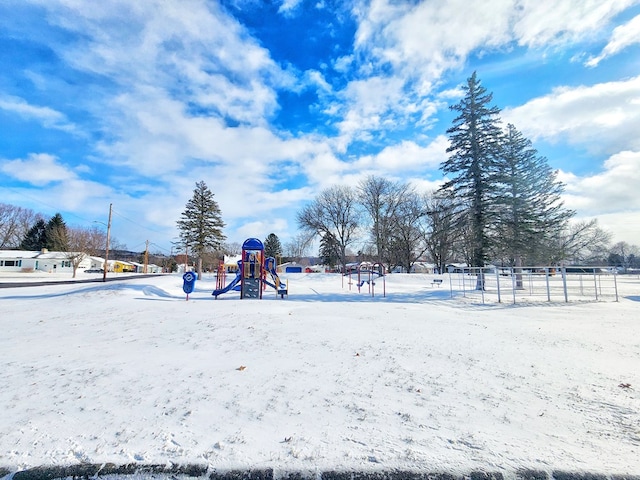 snowy yard with a playground