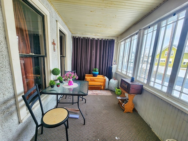 sunroom / solarium featuring wood ceiling