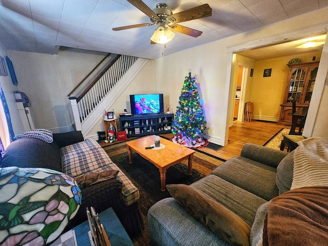 living room featuring ceiling fan and hardwood / wood-style floors