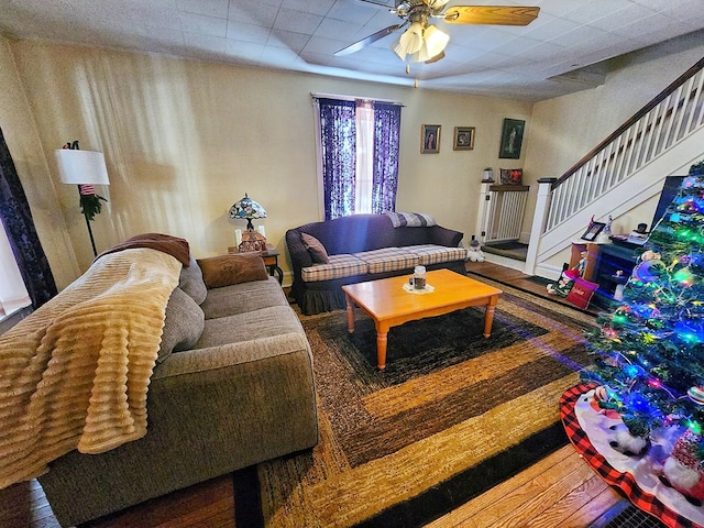 living room featuring ceiling fan and hardwood / wood-style floors