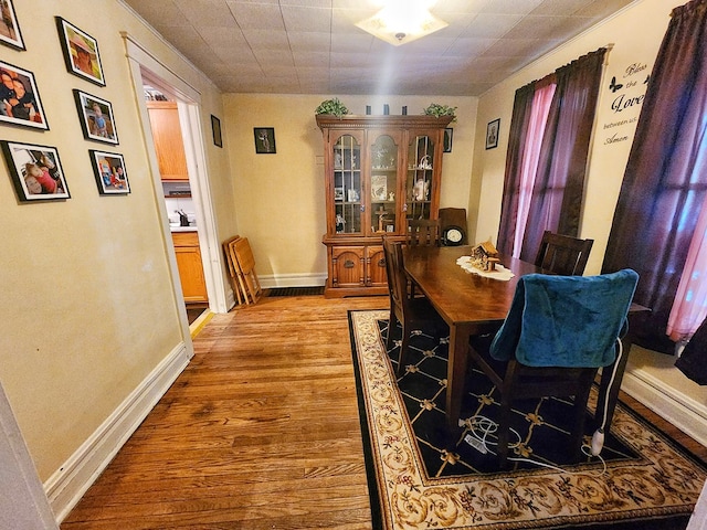 dining room featuring sink and light hardwood / wood-style flooring