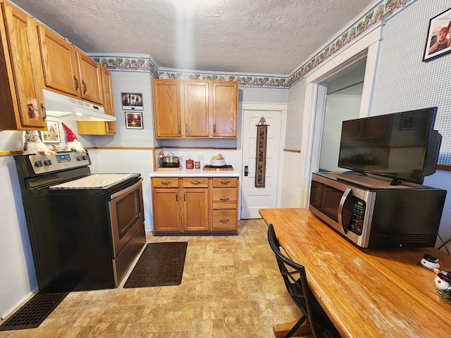 kitchen featuring stainless steel appliances and a textured ceiling