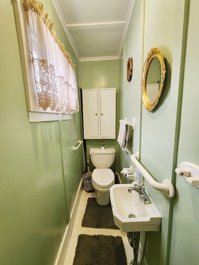 bathroom featuring crown molding, toilet, tile patterned flooring, and sink