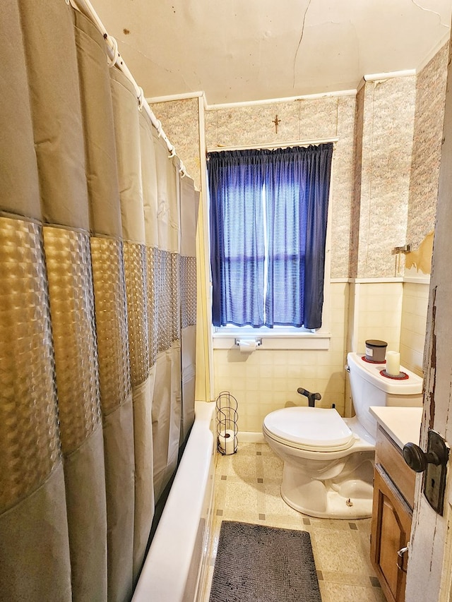 bathroom with tile walls, vanity, a shower with curtain, and toilet