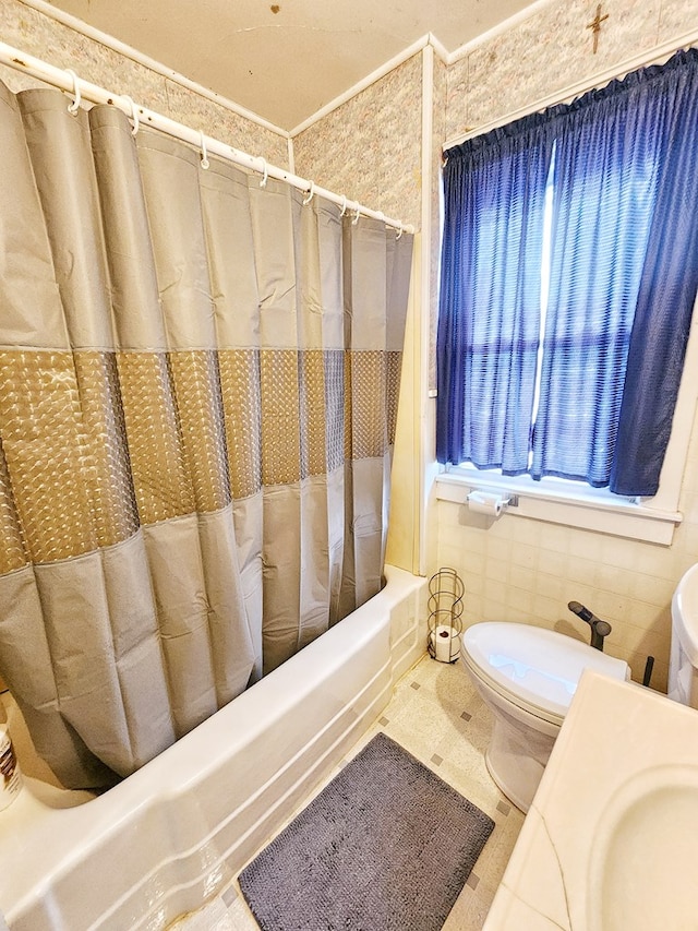 bathroom featuring sink, tile walls, and toilet