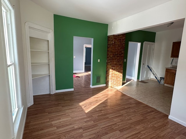 unfurnished room with dark hardwood / wood-style flooring