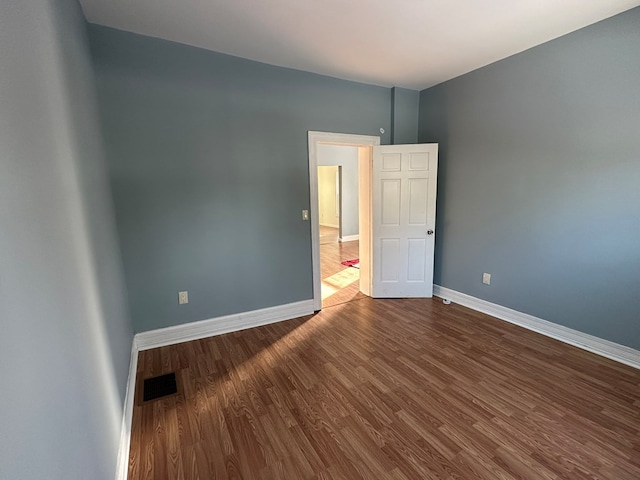 spare room with wood-type flooring