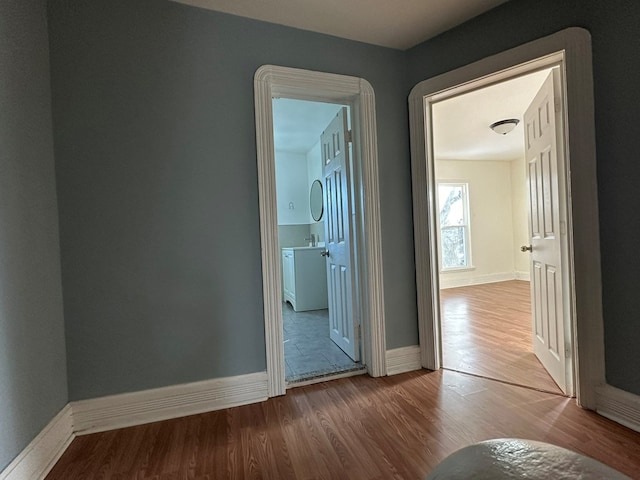 corridor with wood-type flooring