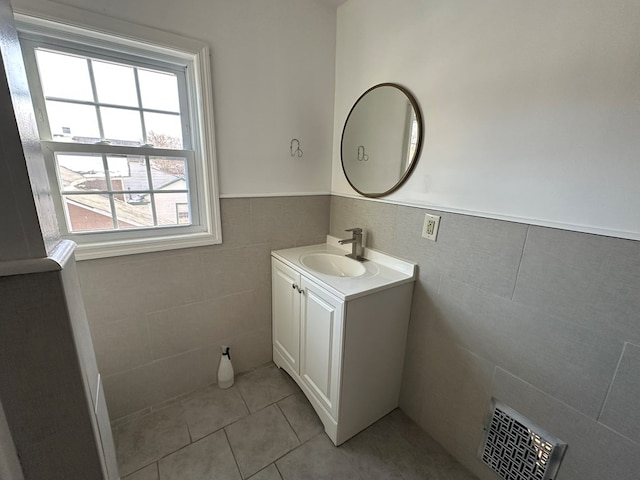 bathroom with vanity, tile patterned flooring, and tile walls