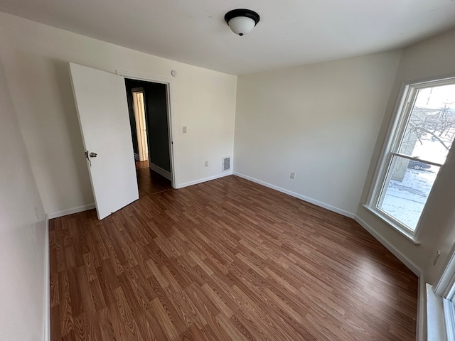 unfurnished room featuring dark hardwood / wood-style floors