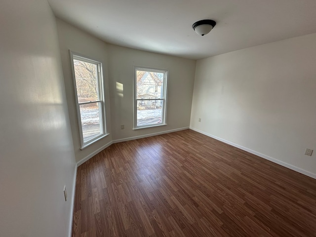 empty room with dark wood-type flooring