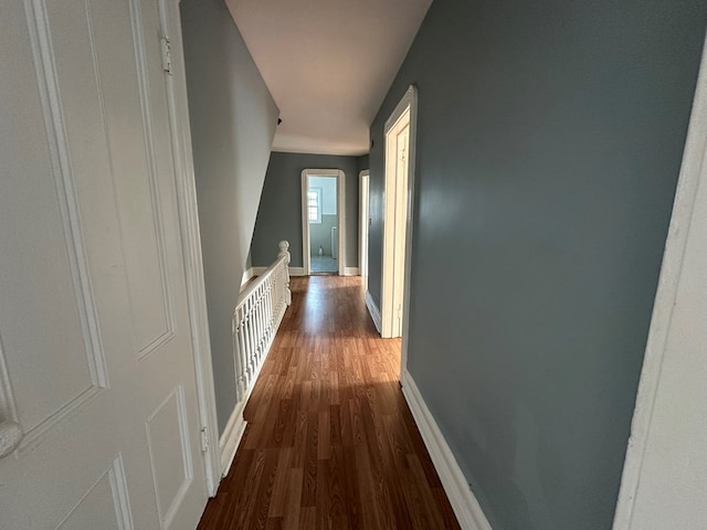 hallway with dark hardwood / wood-style flooring