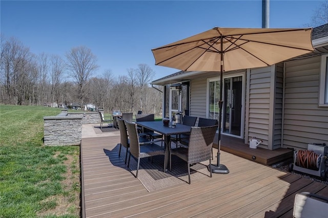 wooden terrace with a lawn