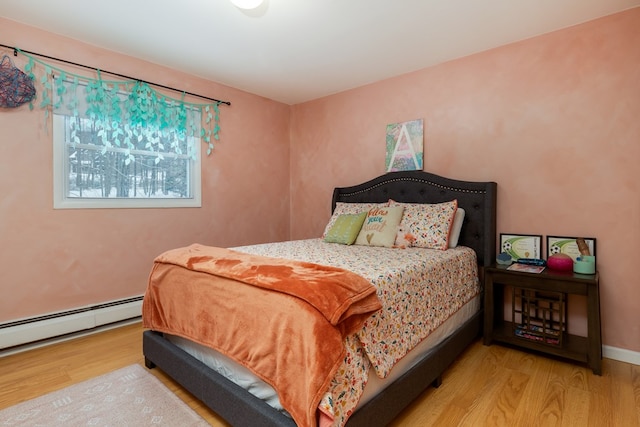 bedroom featuring a baseboard radiator and light wood-type flooring