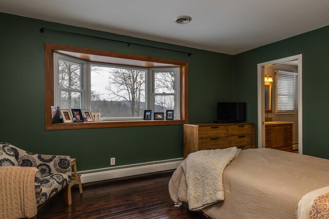 bedroom with a baseboard radiator, connected bathroom, and dark hardwood / wood-style flooring