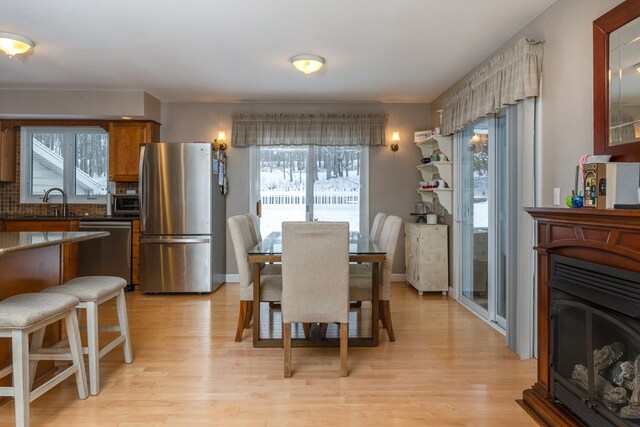 dining room with sink and light hardwood / wood-style flooring