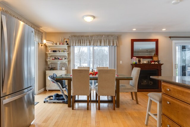 dining space with light hardwood / wood-style floors