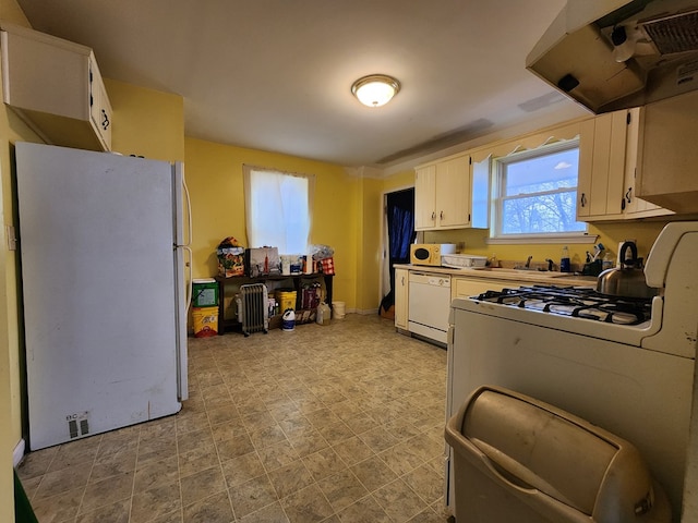 kitchen featuring white appliances, sink, and white cabinets