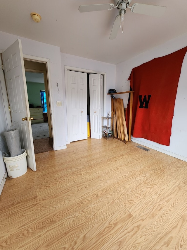 bedroom with light hardwood / wood-style floors and ceiling fan