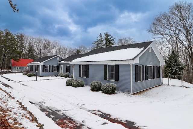 view of snow covered back of property