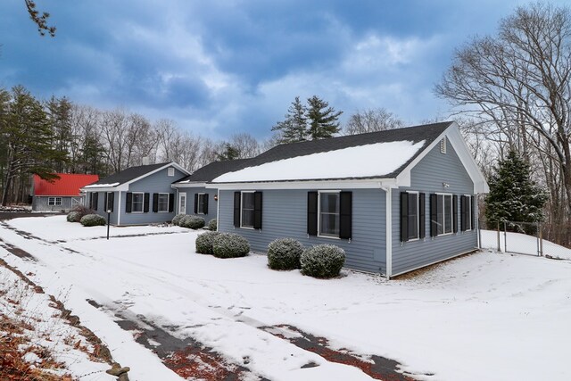 view of snow covered rear of property