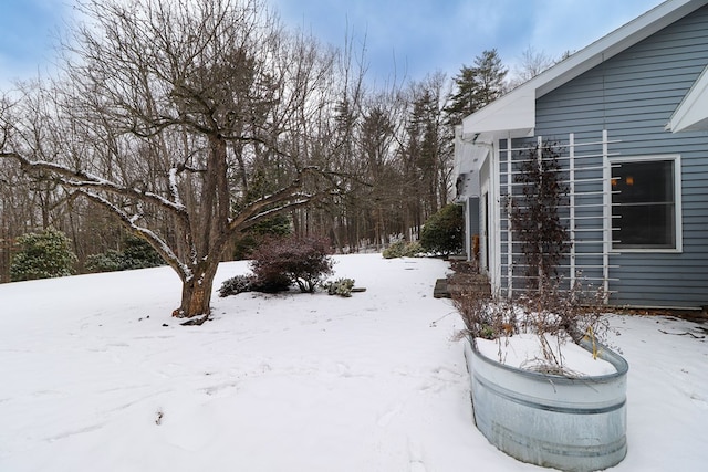 view of yard layered in snow