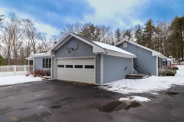 view of snowy exterior with a garage