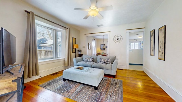 living room with hardwood / wood-style flooring and ceiling fan