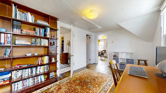 home office with wood-type flooring and a textured ceiling