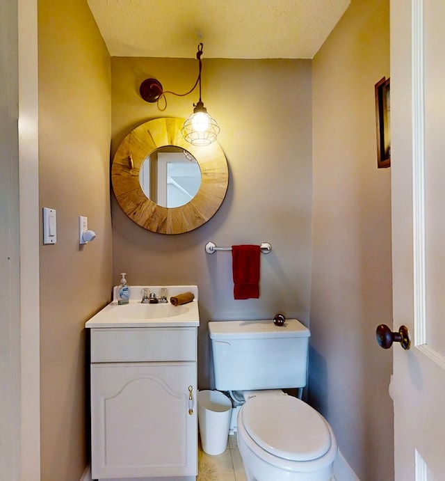 bathroom featuring vanity, tile patterned flooring, and toilet