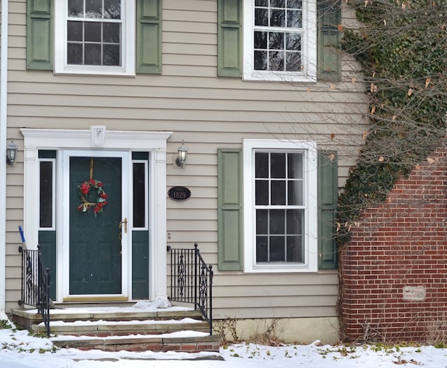 view of snow covered property entrance