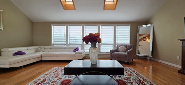 living room featuring dark wood-type flooring and vaulted ceiling with skylight