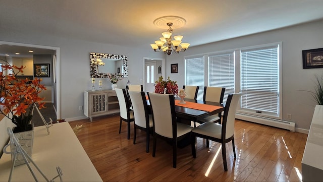 dining area featuring hardwood / wood-style flooring, a baseboard radiator, and a chandelier