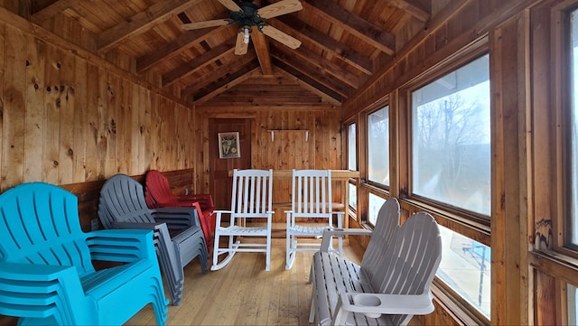 sunroom with vaulted ceiling with beams, a wealth of natural light, wooden ceiling, and ceiling fan